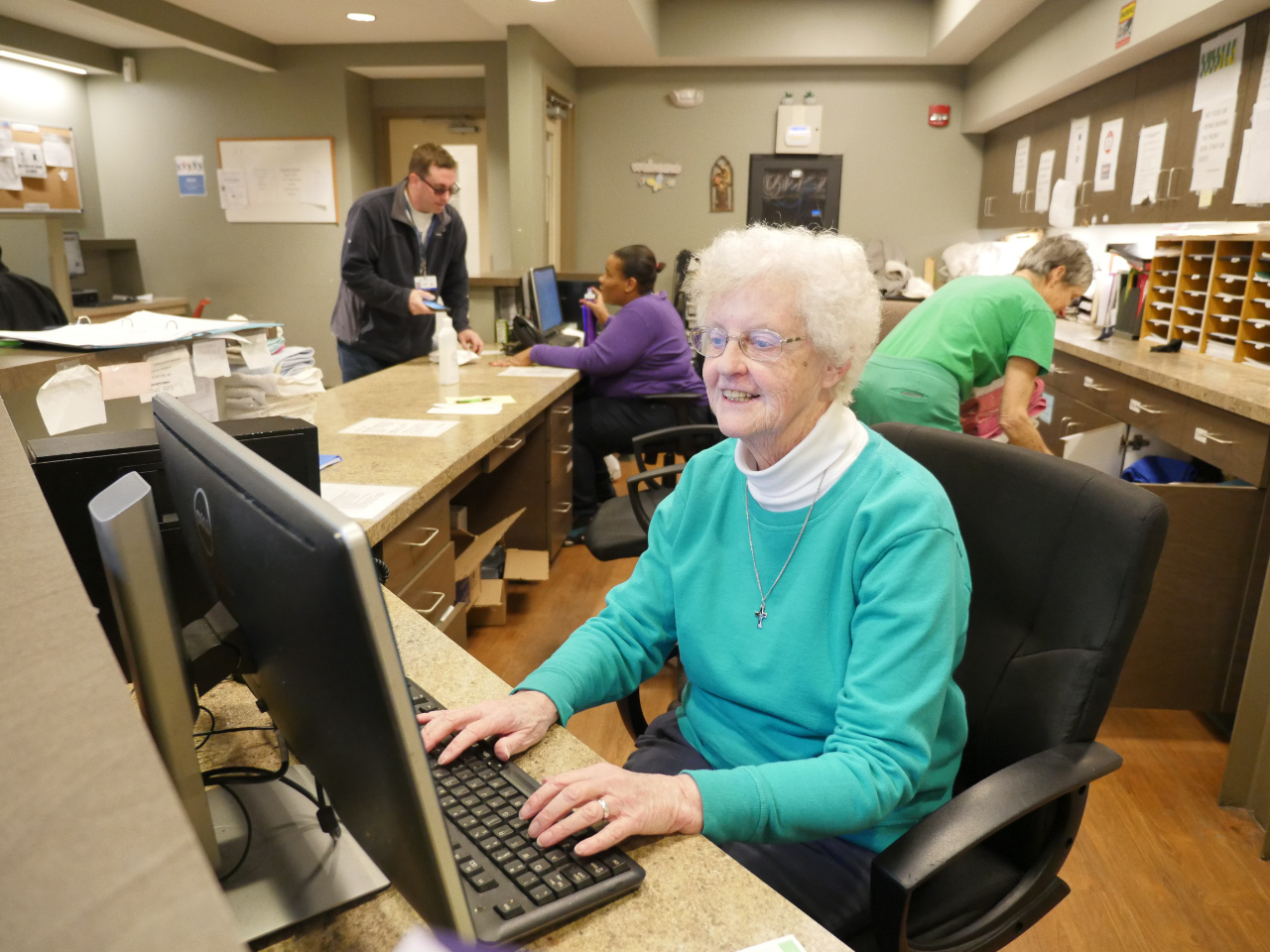 Volunteer at the House of Mercy front desk